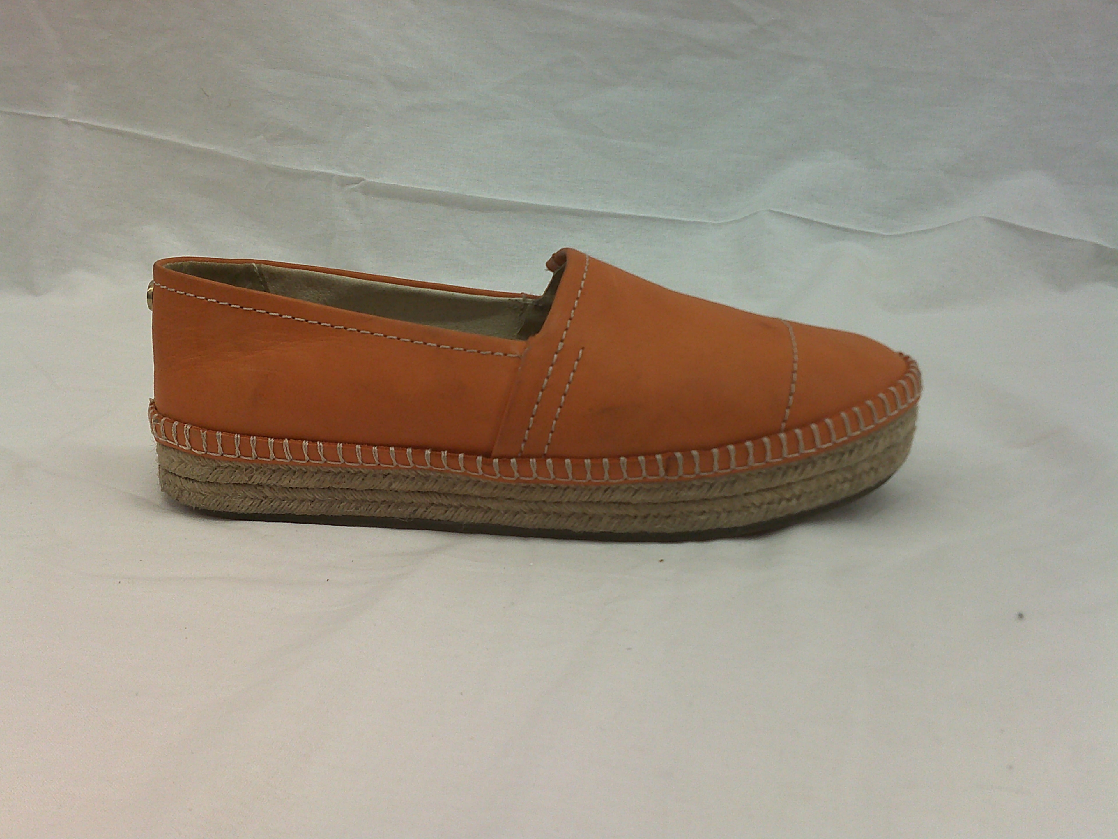 Orange espadrille shoe on a white background